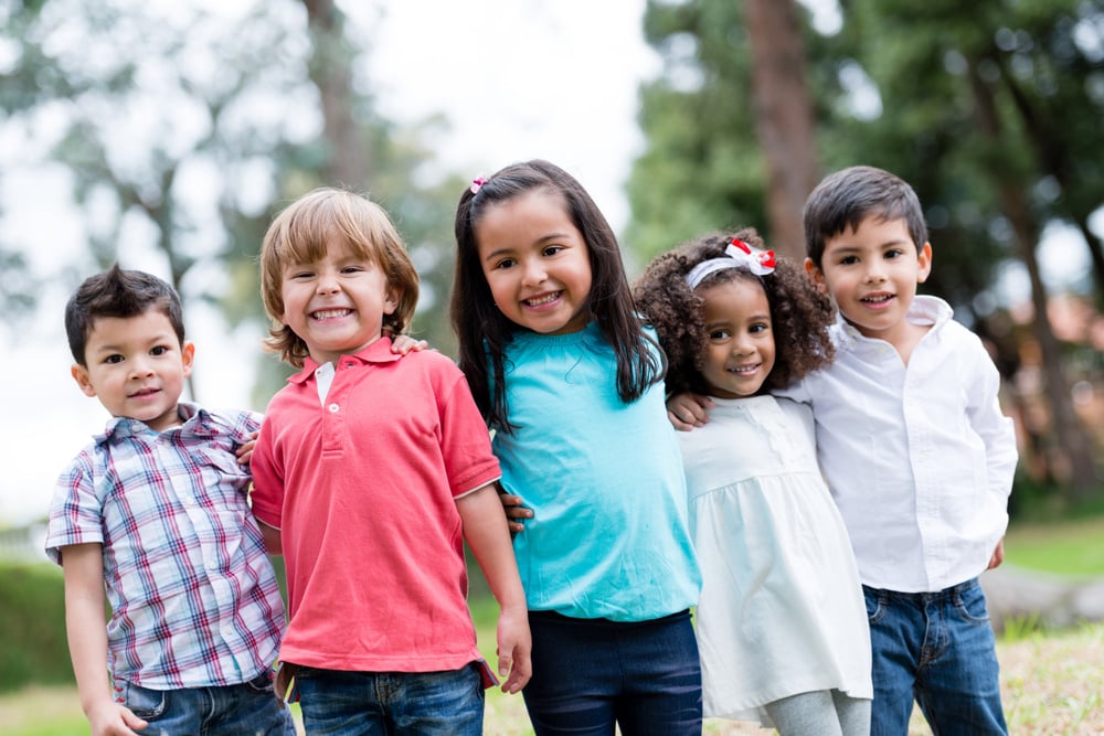Happy group of kids smiling at the park